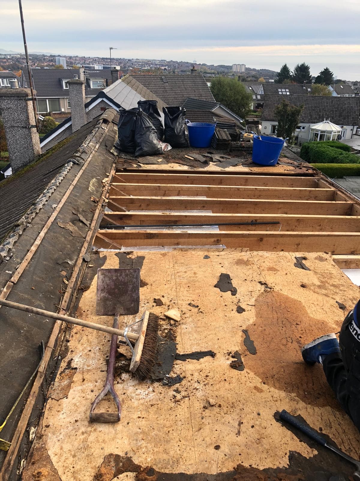 Dormer roof repair in progress showing lead flashing and slate being replaced