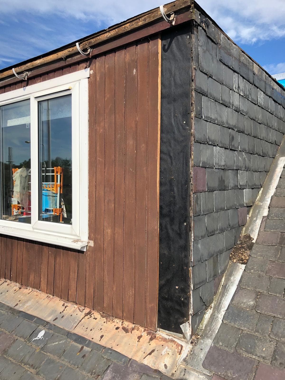 Dark grey slate roof with chimney breast and grey lead flashing
