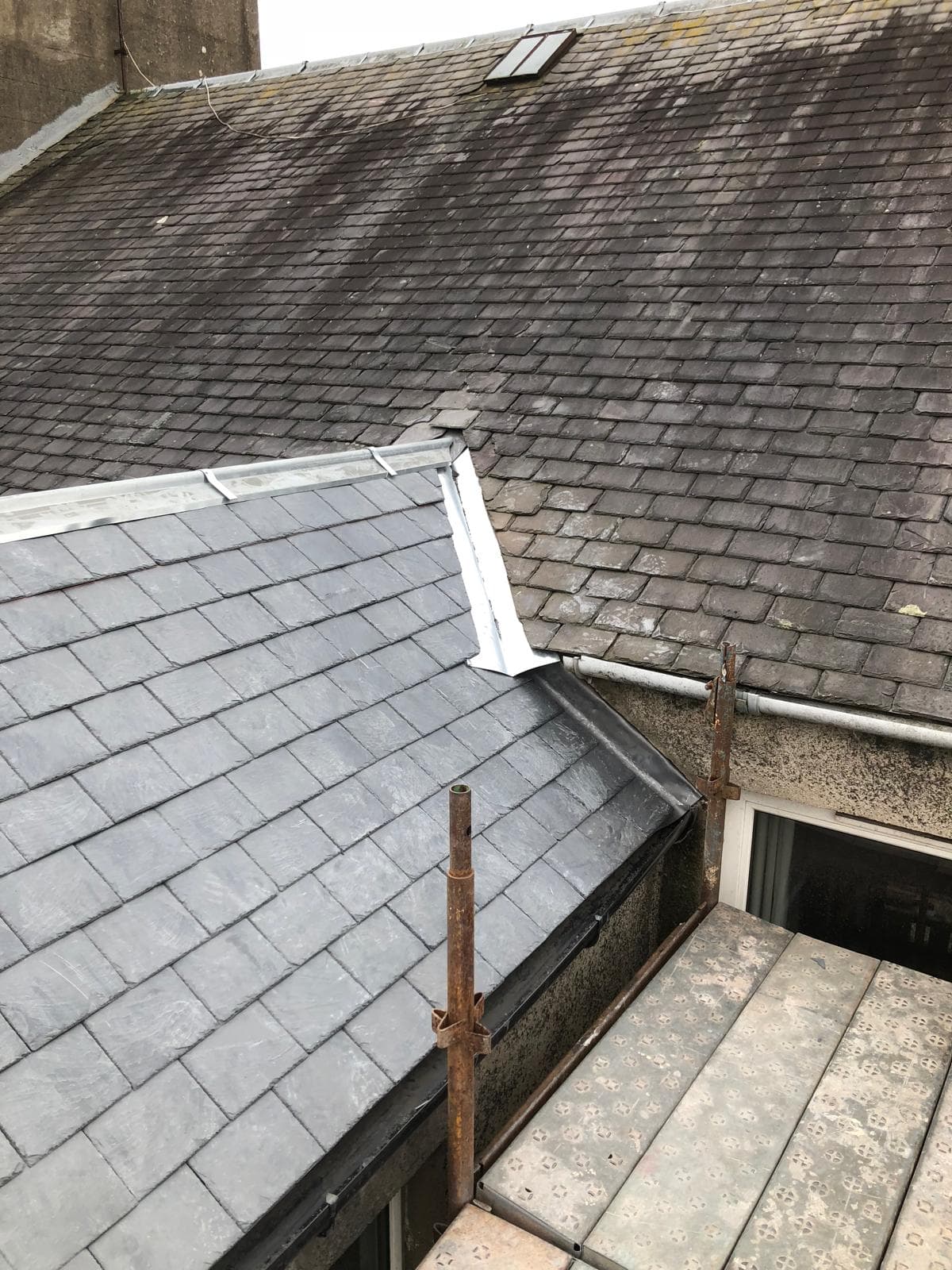 New slate roof with white lead flashing at valley and ridge junctions