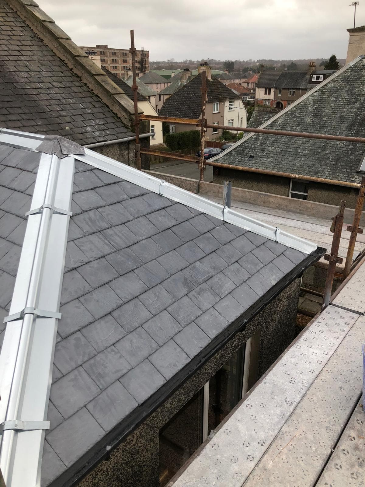 New slate roof with white dry verge system and scaffold on Scottish street